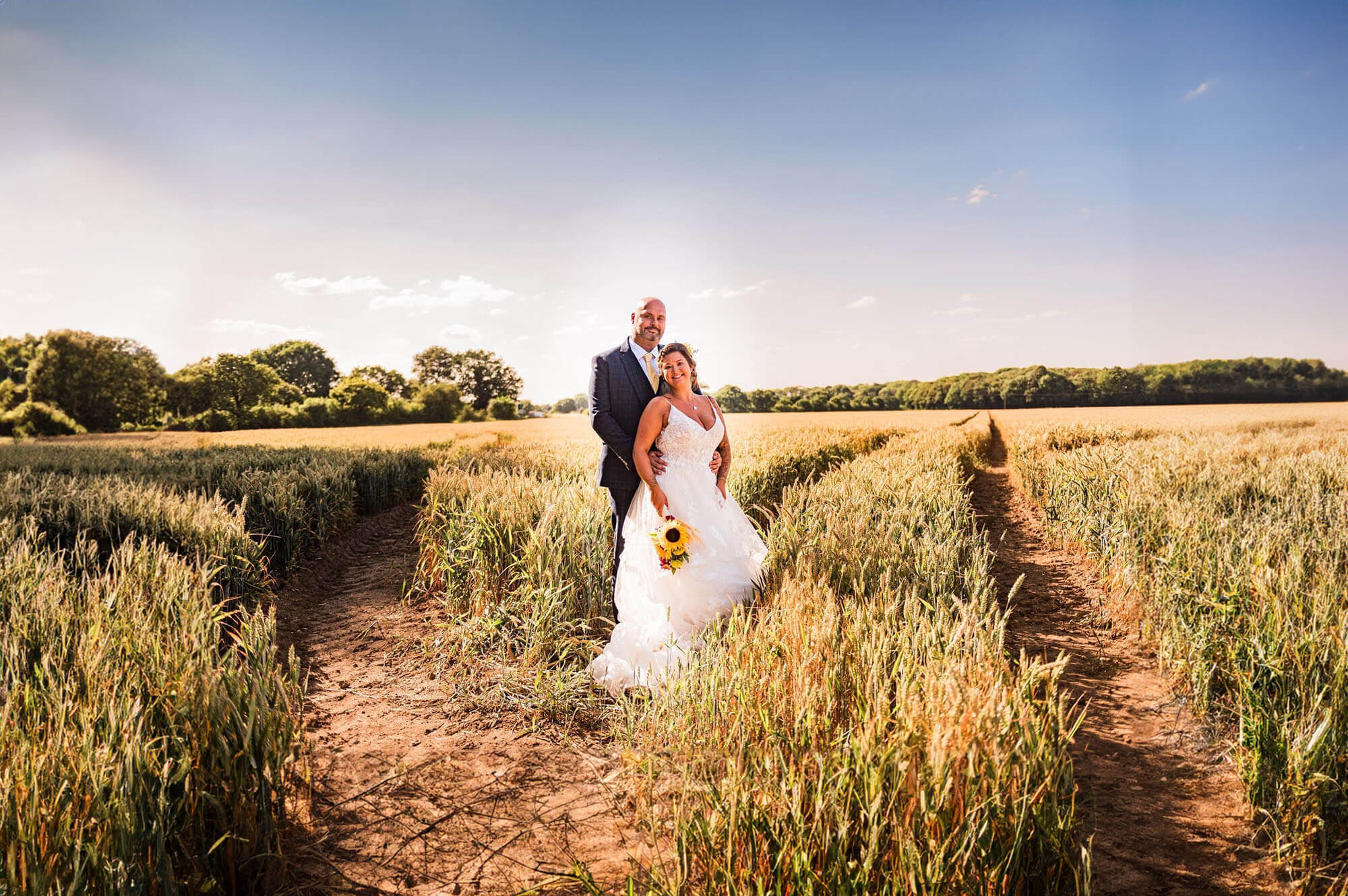 Happy couple standing in a field